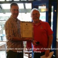 John Sutton receiving a Certificate of Appreciation from Lion Jim Storey John Sutton receiving a Certificate of Appreciation from Lion Jim Storey