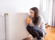 Trying to stay warm by a radiator