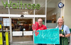 Waitrose Debbie hands over cheque to Lion Jim